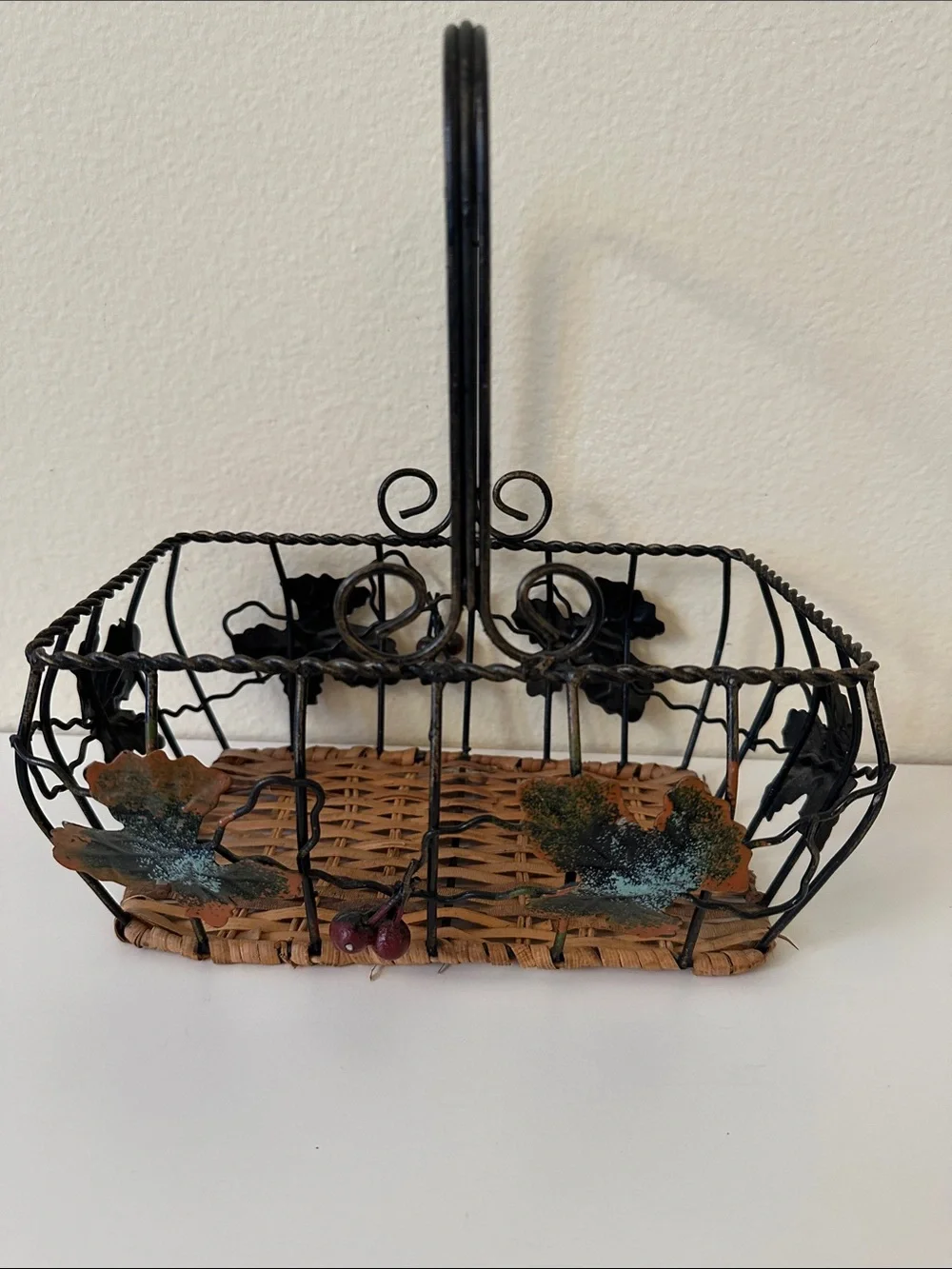 Black Metal and Brown Woven Decorative Basket with Green Leaf Accents